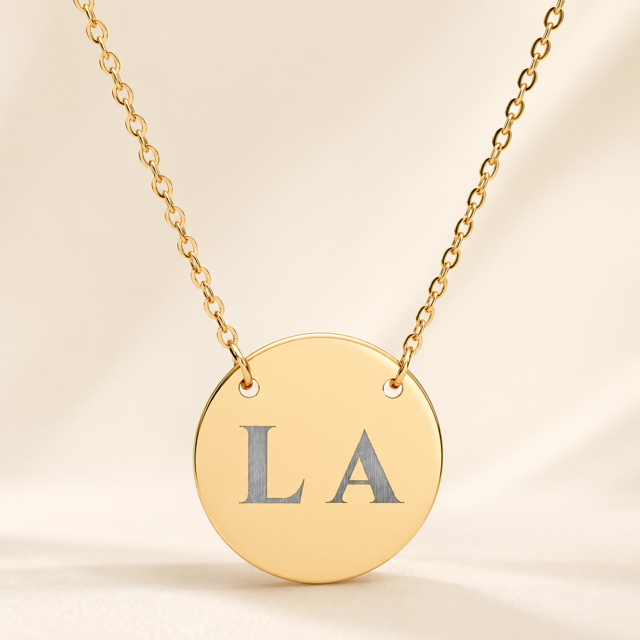 Personalized gold circle necklace with custom engraved initials on 18mm pendant
