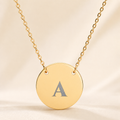 Personalized single initial necklace with custom-engraved letter A on gold circle pendant