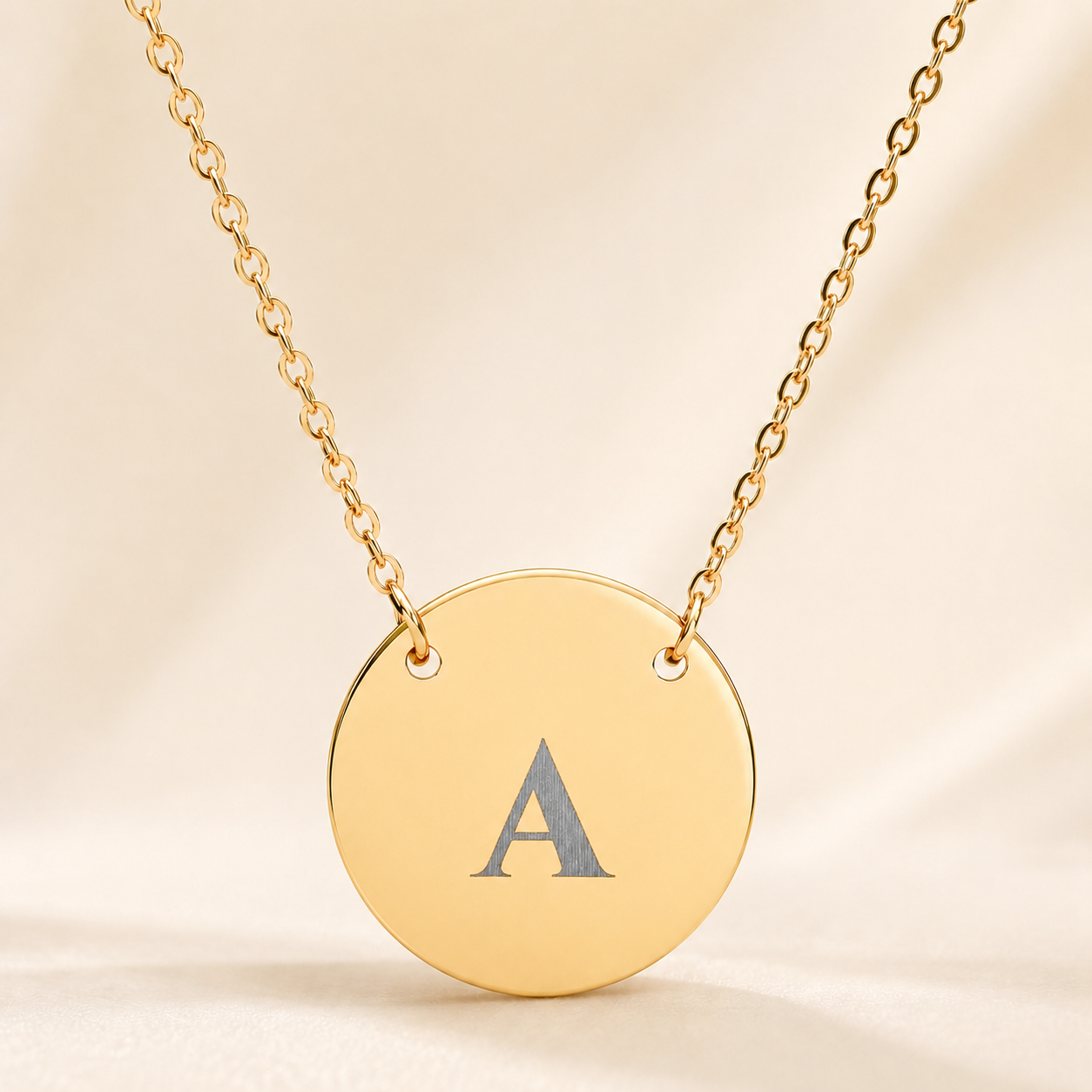 Personalized single initial necklace with custom-engraved letter A on gold circle pendant