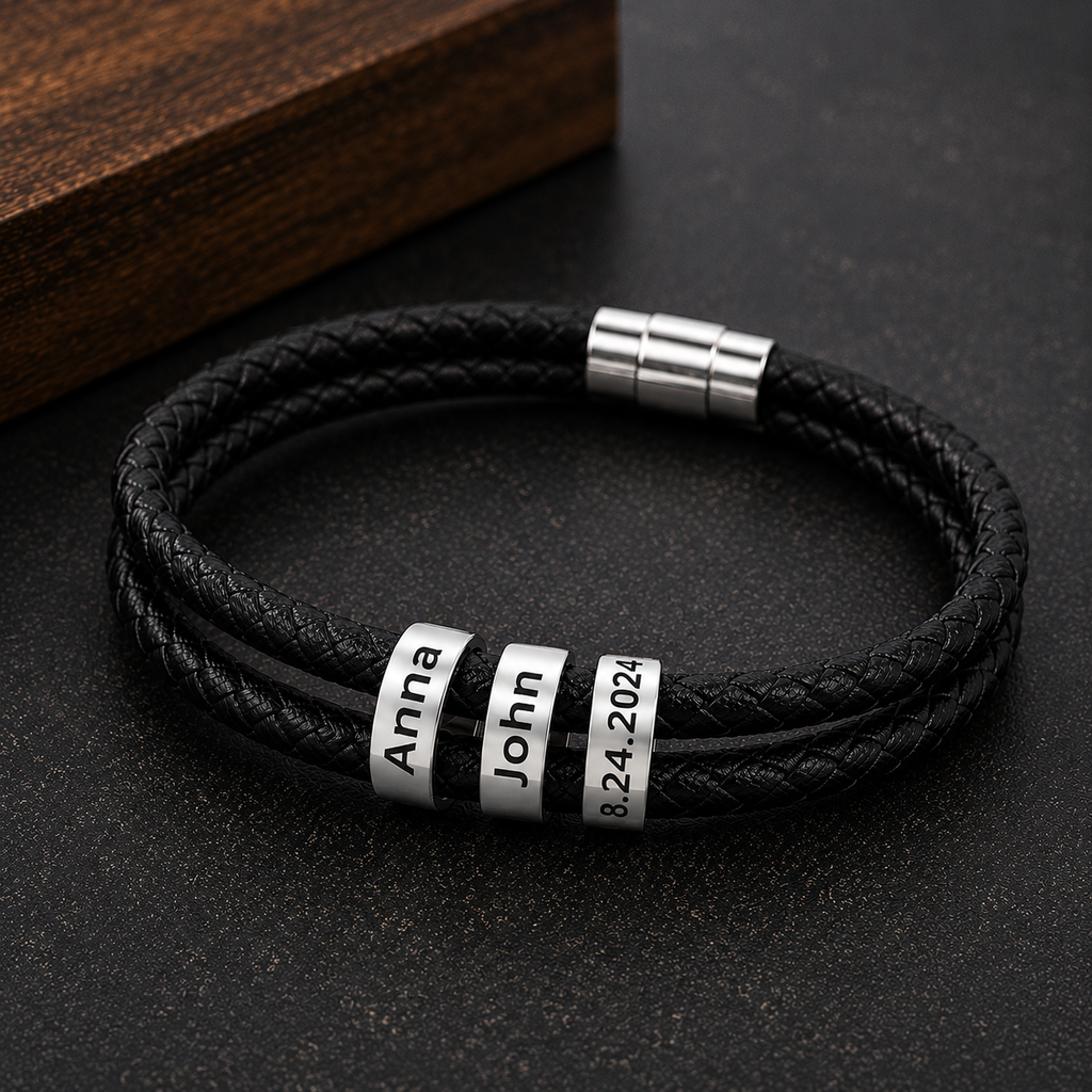 Close-up of engraved couple names and date on leather bracelet