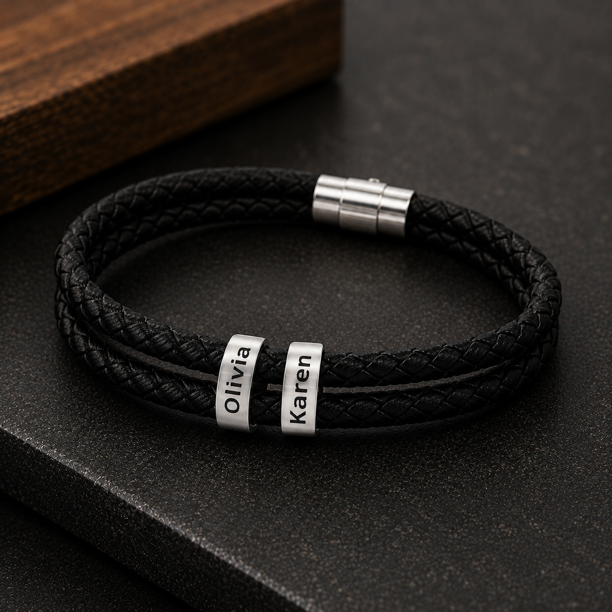 Close-up of two engraved twin names on personalized leather bracelet