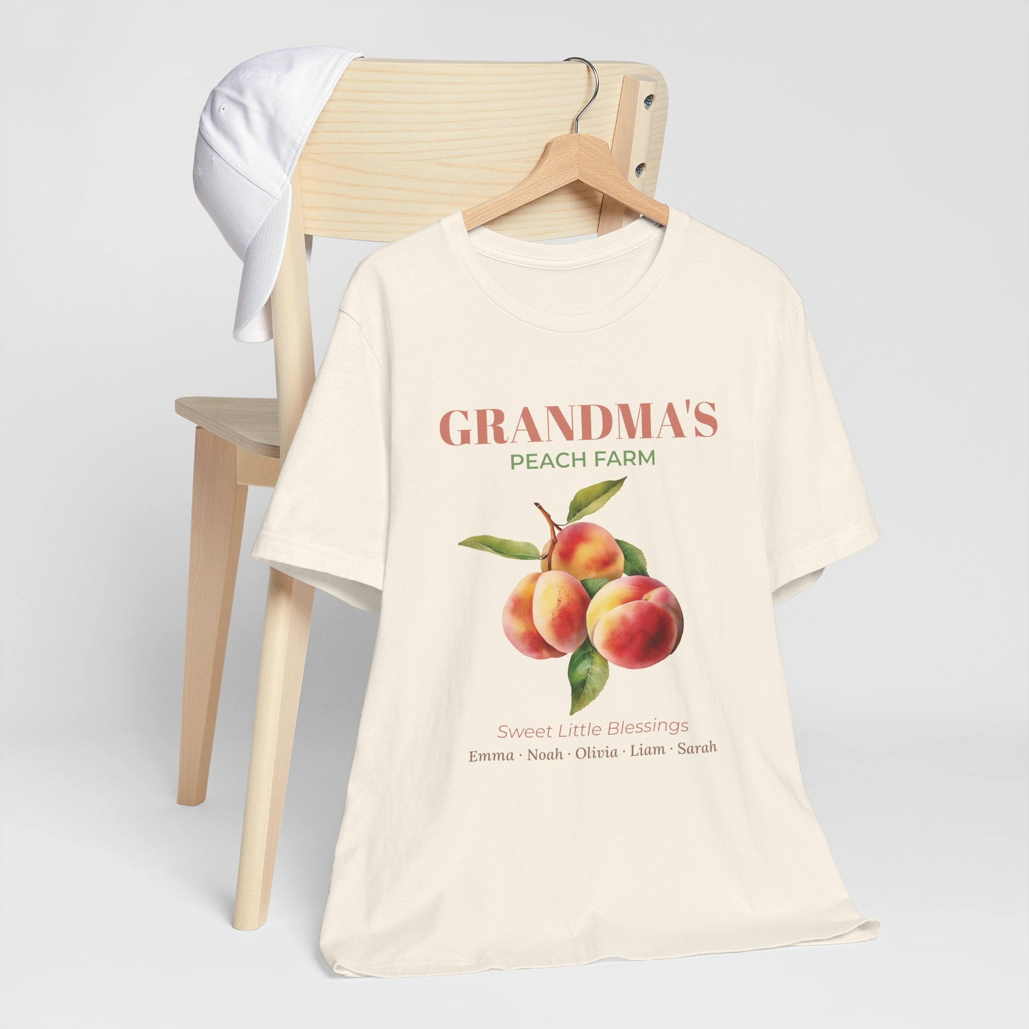 Grandma's Peach Farm personalized t-shirt flat-lay with greenery