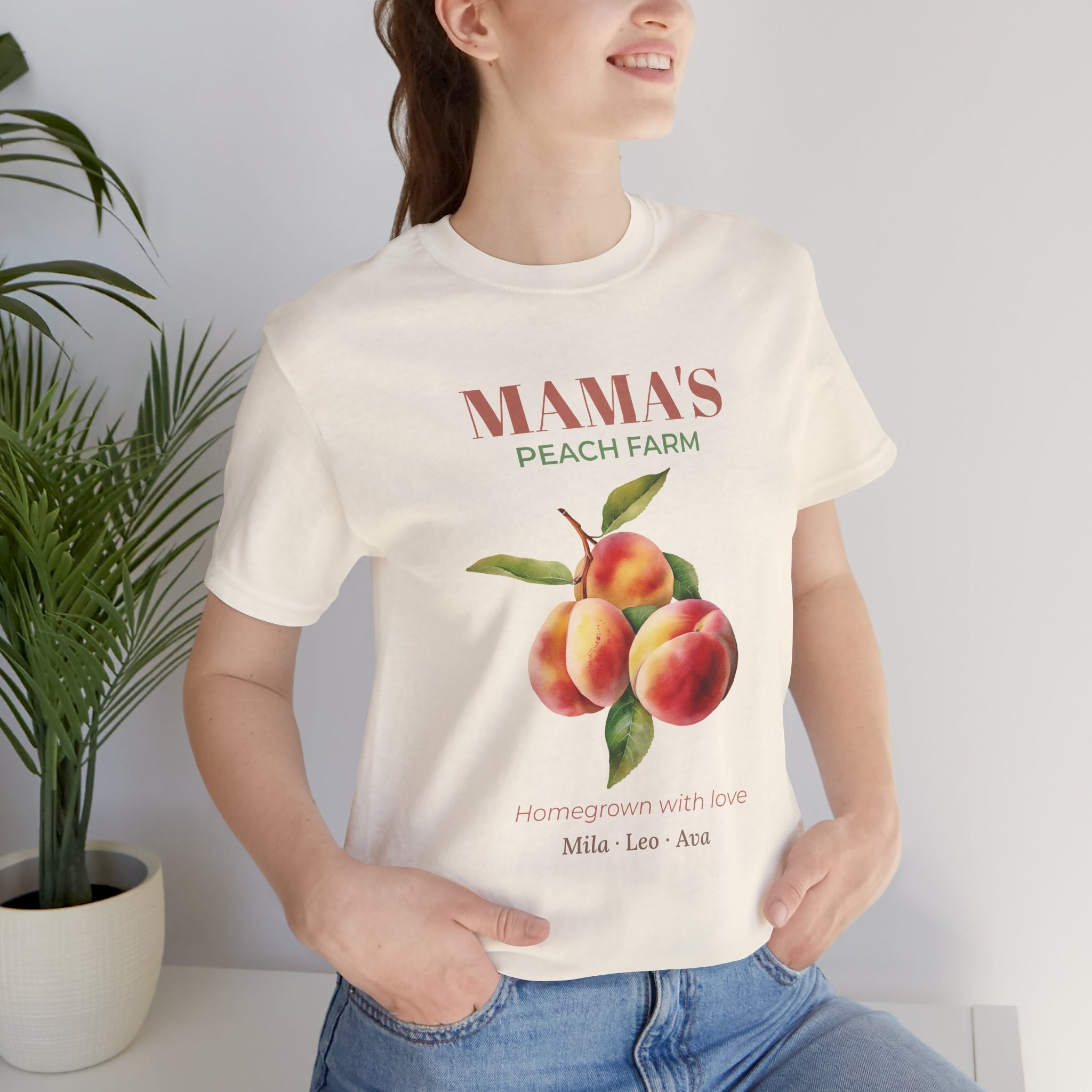 Mama's Peach Farm personalized t-shirt flat-lay with greenery